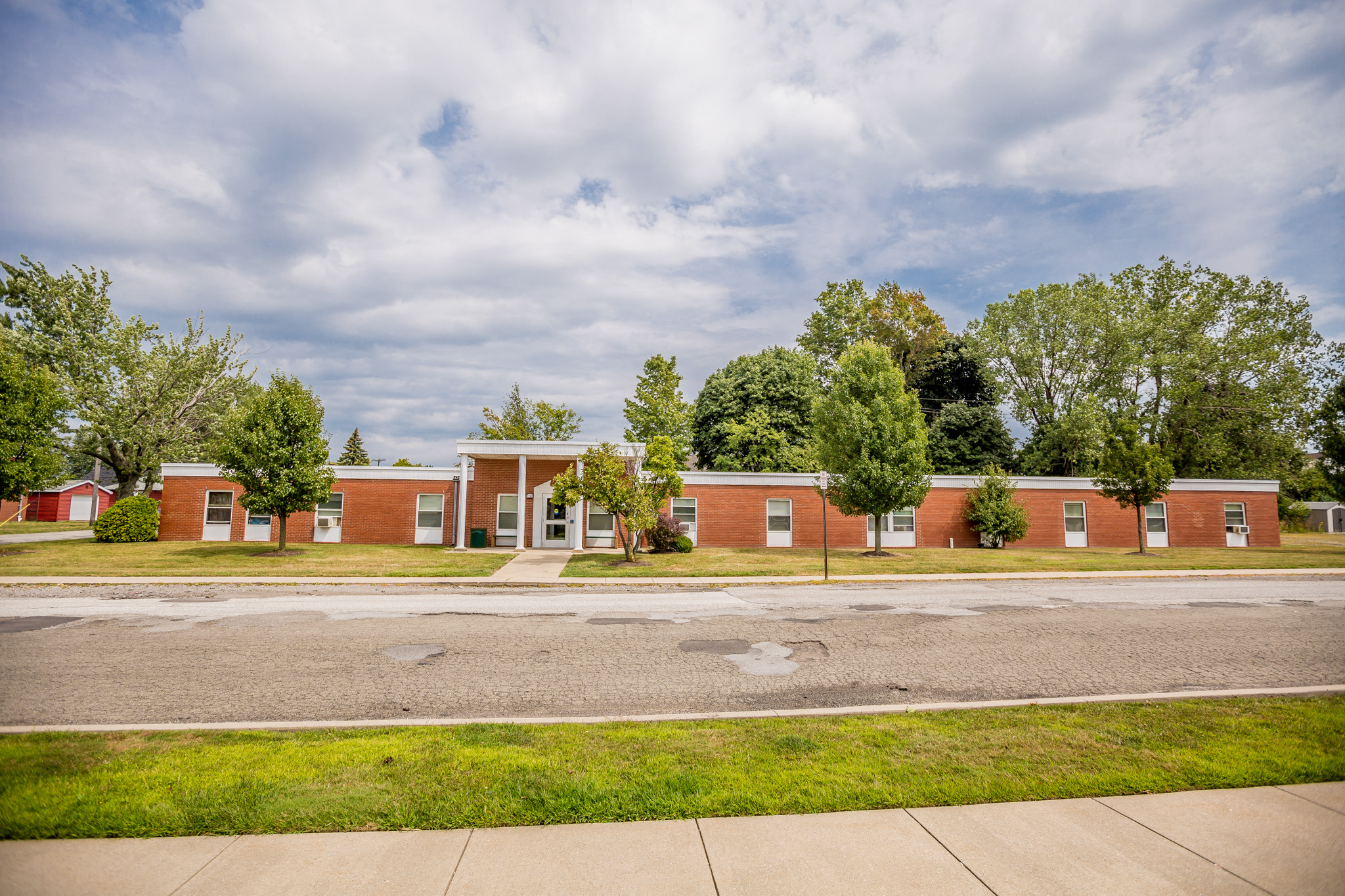 an empty street in front of a brick building